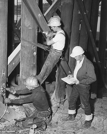 Workers constructing a wooden structure